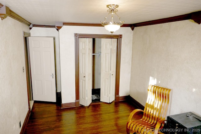 640 W 14th St, Tulsa, OK 74127 - unfurnished bedroom with wood finished floors, ornamental molding, a closet, and baseboards