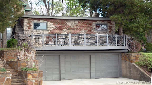 640 W 14th St, Tulsa, OK 74127 - view of front facade with a balcony, a garage, and driveway