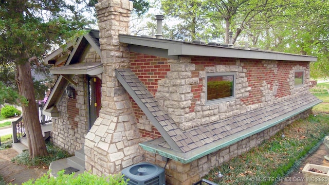 640 W 14th St, Tulsa, OK 74127 - view of home's exterior with a chimney and central AC