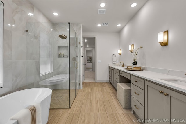 4127 S Cincinnati Ave, Tulsa, OK 74105 - bathroom featuring double vanity, a freestanding bath, a shower stall, and recessed lighting
