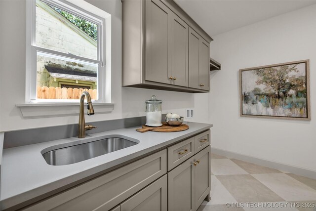 4127 S Cincinnati Ave, Tulsa, OK 74105 - kitchen featuring a sink, gray cabinetry, light countertops, and baseboards