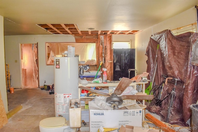 1108 E E Blf, Hugo, OK 74743 - miscellaneous room with water heater and concrete flooring