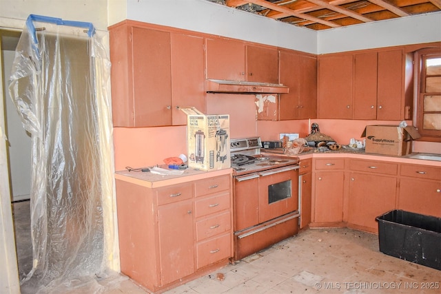 1108 E E Blf, Hugo, OK 74743 - kitchen featuring stove, under cabinet range hood, and light countertops