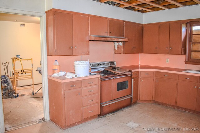 1108 E E Blf, Hugo, OK 74743 - kitchen with double oven range, under cabinet range hood, and light countertops