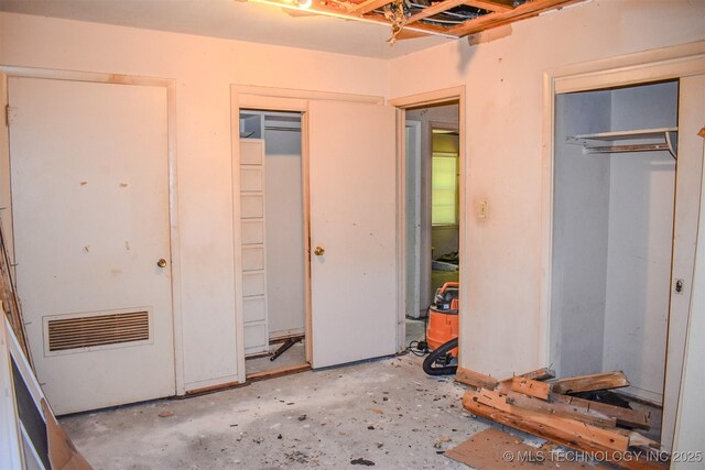 1108 E E Blf, Hugo, OK 74743 - unfurnished bedroom with multiple closets and concrete flooring