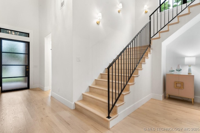 4165 S Rockford Pl, Tulsa, OK 74105 - entryway with wood finished floors, a high ceiling, baseboards, and stairs