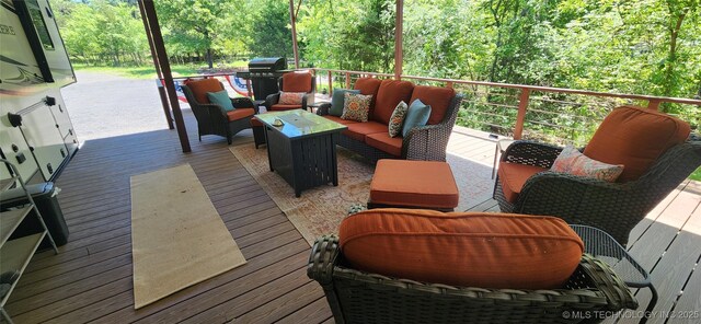 140 Last Resort Rd, Stigler, OK 74462 - wooden terrace with outdoor lounge area, a wooded view, and a grill