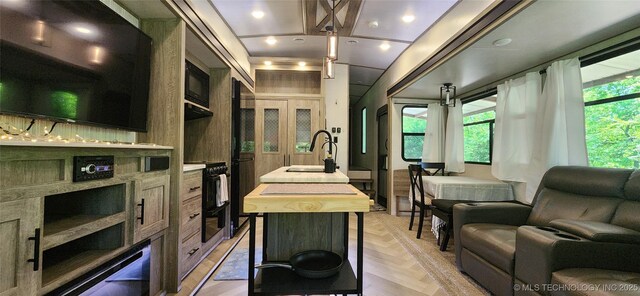 140 Last Resort Rd, Stigler, OK 74462 - kitchen featuring a sink, open floor plan, a center island with sink, wooden counters, and decorative light fixtures