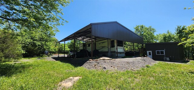 140 Last Resort Rd, Stigler, OK 74462 - rear view of house with an outdoor structure and a lawn