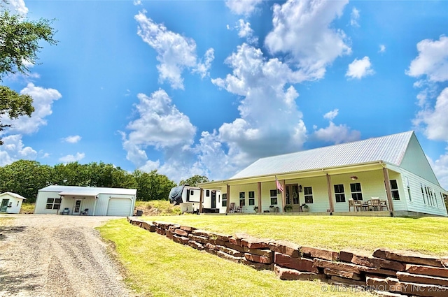 157 Canna Ln, Mcalester, OK 74501 - view of front of home with driveway, a metal roof, a front yard, and a garage
