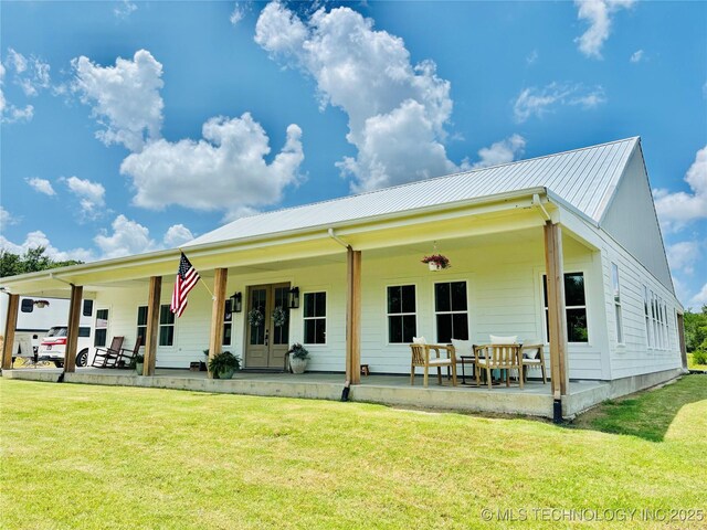 157 Canna Ln, Mcalester, OK 74501 - back of property featuring a lawn, a metal roof, french doors, and a patio area