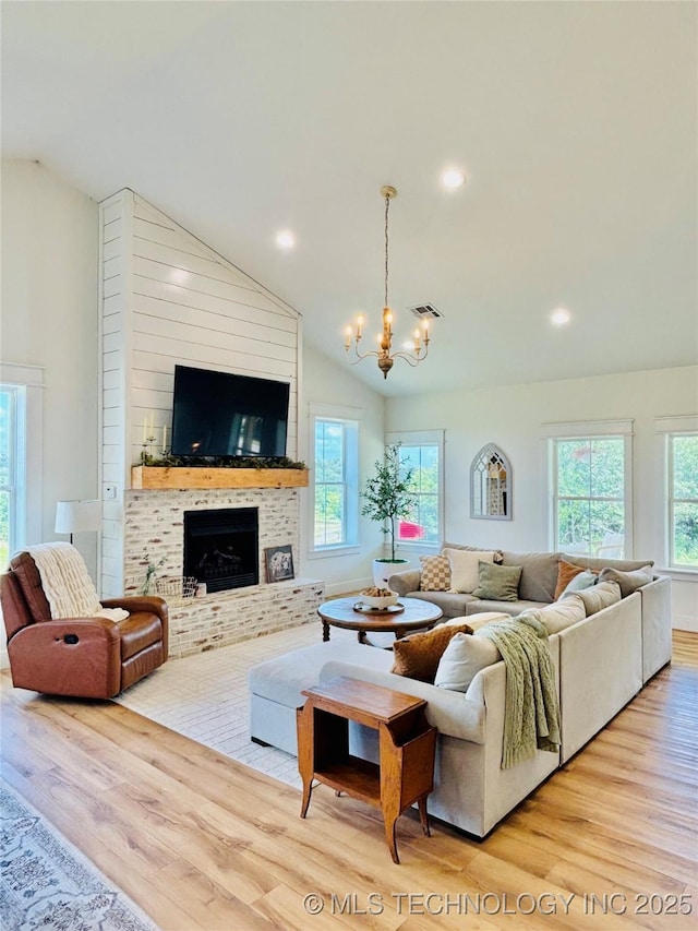 157 Canna Ln, Mcalester, OK 74501 - living room with wood finished floors, a brick fireplace, a chandelier, high vaulted ceiling, and recessed lighting