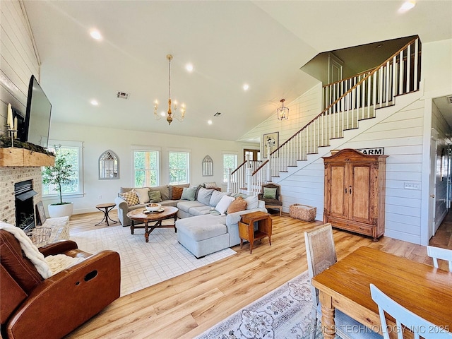 157 Canna Ln, Mcalester, OK 74501 - living room with stairs, a brick fireplace, light wood-type flooring, a chandelier, and recessed lighting