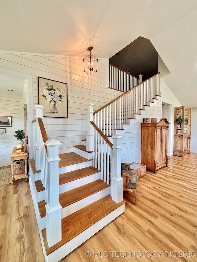 157 Canna Ln, Mcalester, OK 74501 - stairs with wood finished floors, wooden walls, and a chandelier