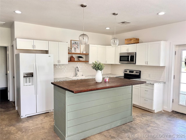 157 Canna Ln, Mcalester, OK 74501 - kitchen featuring appliances with stainless steel finishes, finished concrete flooring, tasteful backsplash, white cabinets, and recessed lighting
