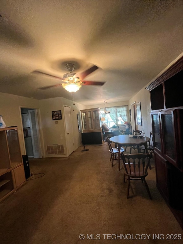 1003 E 4th St, Cushing, OK 74023 - dining area with a textured ceiling, a ceiling fan, and carpet