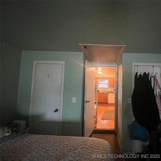 1003 E 4th St, Cushing, OK 74023 - bedroom featuring attic access, a closet, and a sink