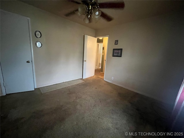 1003 E 4th St, Cushing, OK 74023 - unfurnished bedroom with carpet flooring, baseboards, and a ceiling fan