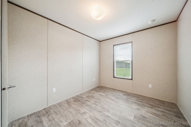 348939 E 750th Rd, Cushing, OK 74023 - spare room featuring wood finished floors, a smoke detector, and crown molding