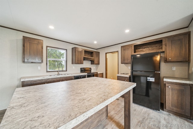 348939 E 750th Rd, Cushing, OK 74023 - kitchen featuring freestanding refrigerator, open shelves, range with electric cooktop, a sink, and light wood-style floors