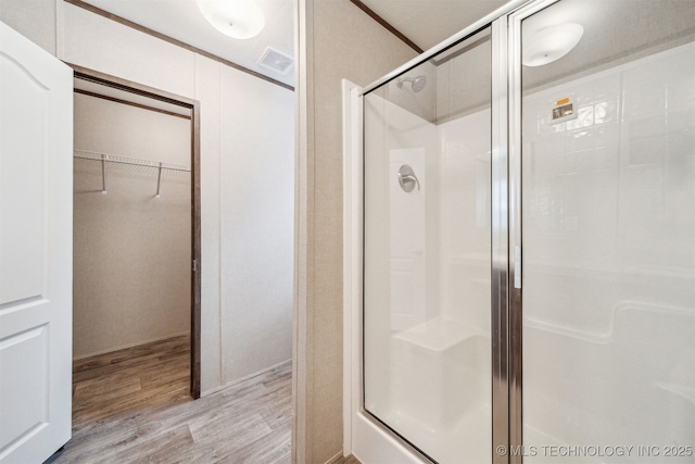 348939 E 750th Rd, Cushing, OK 74023 - bathroom with wood finished floors, a shower stall, and a walk in closet