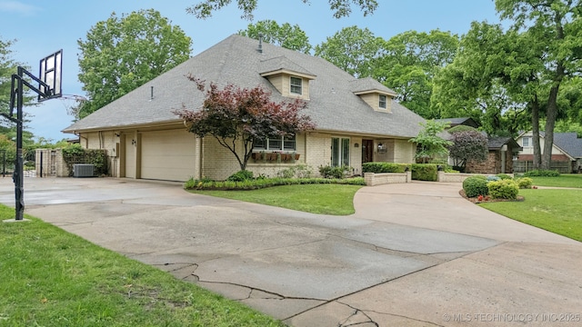 1209 Sherwood Ln, Broken Arrow, OK 74011 - view of front of house with driveway, cooling unit, a front lawn, brick siding, and a garage