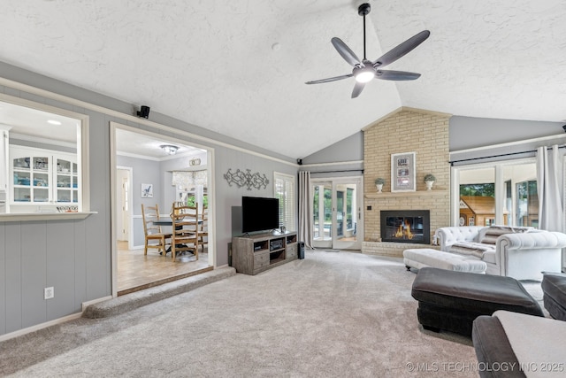 1209 Sherwood Ln, Broken Arrow, OK 74011 - living room featuring a textured ceiling, a ceiling fan, carpet flooring, lofted ceiling, and a fireplace