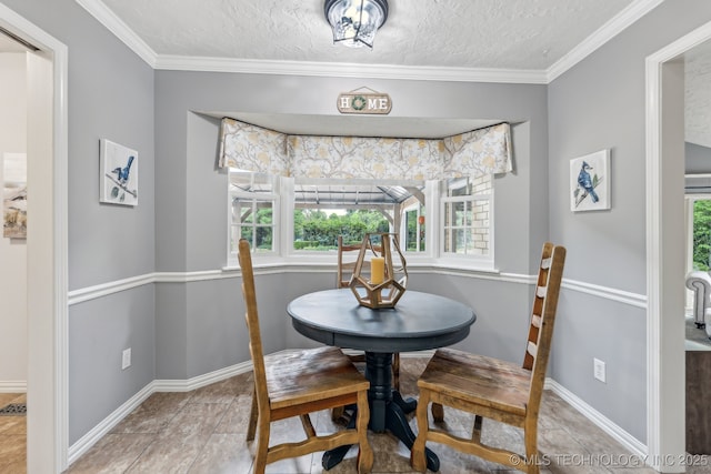 1209 Sherwood Ln, Broken Arrow, OK 74011 - dining room featuring baseboards, a textured ceiling, and ornamental molding