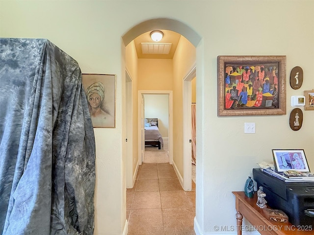 1318 Emily Ln, Ada, OK 74820 - hall with arched walkways, tile patterned flooring, and baseboards