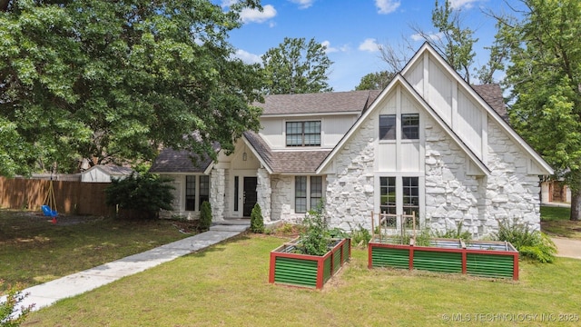 11033 E 66th St, Tulsa, OK 74133 - view of front of property with stone siding, a vegetable garden, and roof with shingles