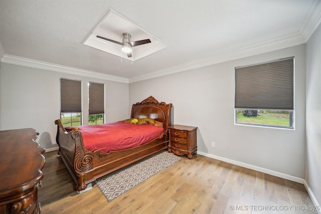 11033 E 66th St, Tulsa, OK 74133 - bedroom with crown molding, multiple windows, baseboards, and wood finished floors