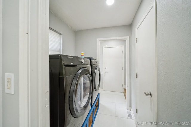 11033 E 66th St, Tulsa, OK 74133 - laundry room featuring washing machine and clothes dryer and light tile patterned floors