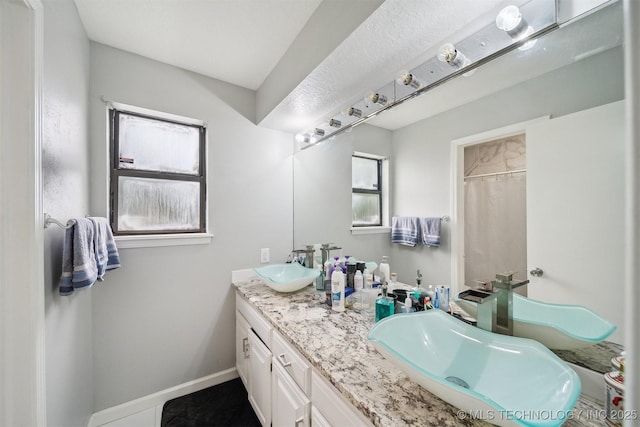 11033 E 66th St, Tulsa, OK 74133 - full bath featuring double vanity and baseboards