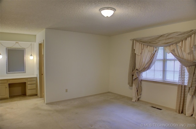 4004 S Hickory Ave, Broken Arrow, OK 74011 - unfurnished bedroom with light colored carpet, a textured ceiling, baseboards, and a desk