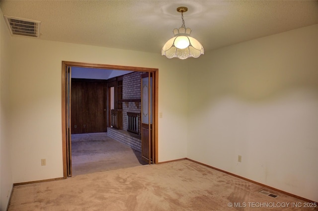 4004 S Hickory Ave, Broken Arrow, OK 74011 - spare room featuring light carpet, a brick fireplace, baseboards, and a textured ceiling