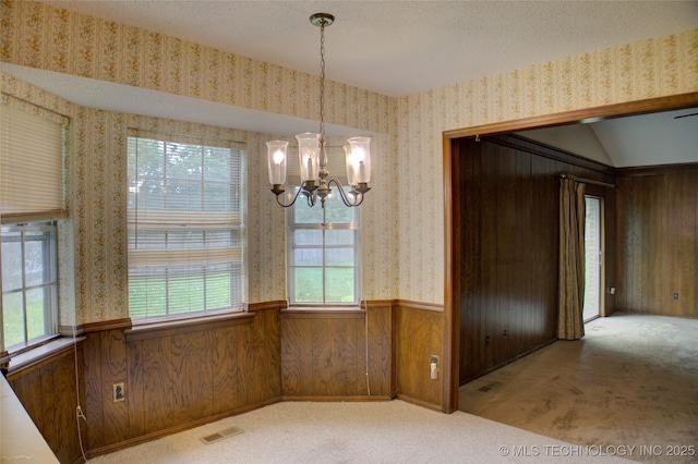 4004 S Hickory Ave, Broken Arrow, OK 74011 - unfurnished dining area featuring a chandelier, carpet, wainscoting, wallpapered walls, and wooden walls