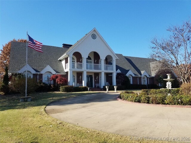 66235 S 320th Rd, Chouteau, OK 74337 - view of front of house featuring a balcony and a front yard