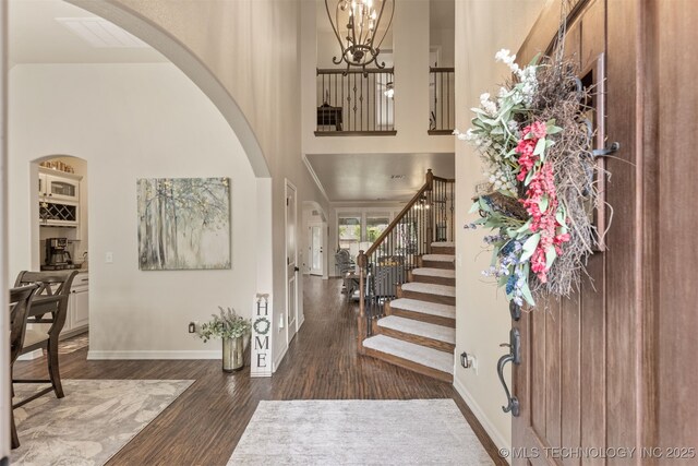 3117 S Hemlock Ct, Broken Arrow, OK 74012 - foyer with arched walkways, a high ceiling, wood finished floors, stairway, and a chandelier