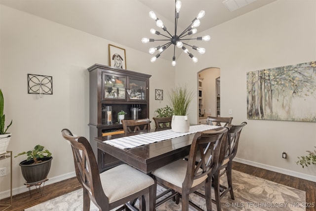 3117 S Hemlock Ct, Broken Arrow, OK 74012 - dining area featuring arched walkways, a chandelier, wood finished floors, and baseboards