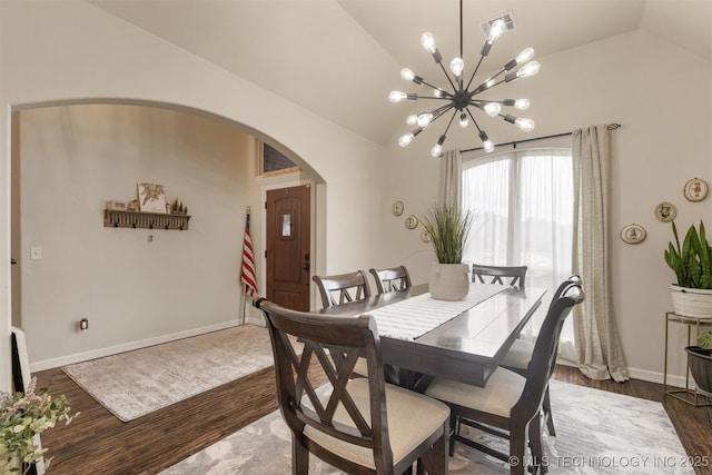 3117 S Hemlock Ct, Broken Arrow, OK 74012 - dining space featuring arched walkways, a chandelier, wood finished floors, vaulted ceiling, and baseboards