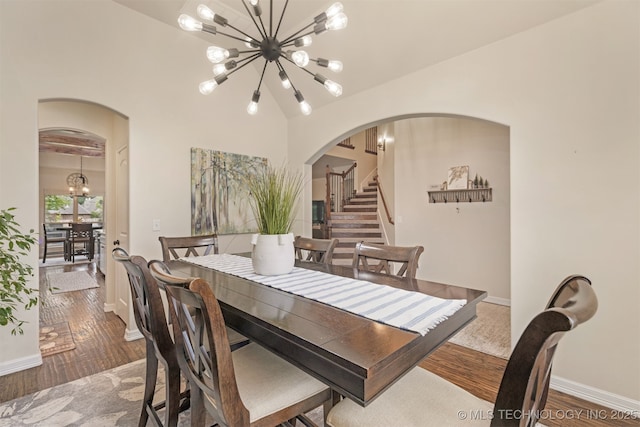 3117 S Hemlock Ct, Broken Arrow, OK 74012 - dining space featuring arched walkways, a chandelier, wood finished floors, stairway, and baseboards