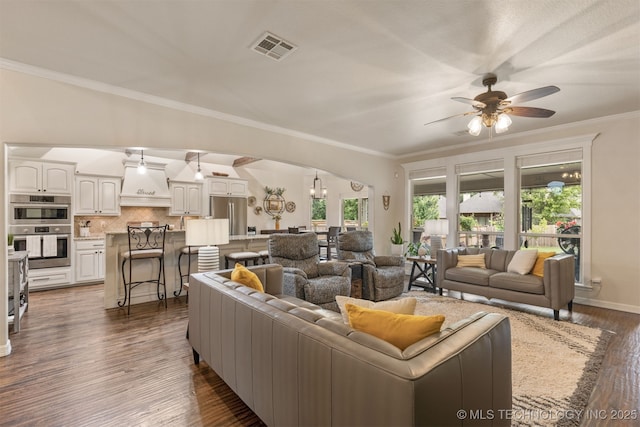 3117 S Hemlock Ct, Broken Arrow, OK 74012 - living room with arched walkways, a ceiling fan, dark wood finished floors, crown molding, and baseboards