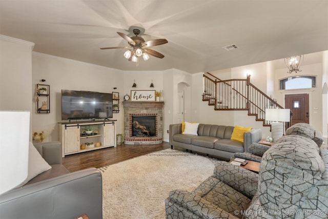 3117 S Hemlock Ct, Broken Arrow, OK 74012 - living room with stairway, wood finished floors, ceiling fan, a brick fireplace, and arched walkways