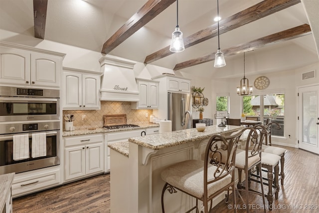 3117 S Hemlock Ct, Broken Arrow, OK 74012 - kitchen with appliances with stainless steel finishes, backsplash, dark wood-type flooring, a chandelier, and light stone countertops
