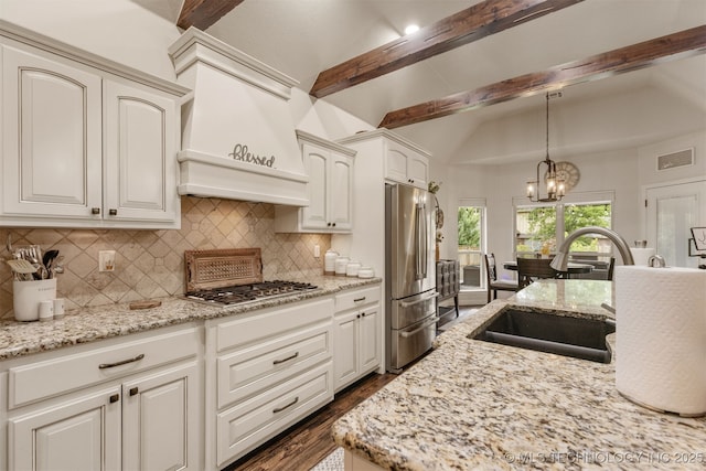 3117 S Hemlock Ct, Broken Arrow, OK 74012 - kitchen with appliances with stainless steel finishes, a sink, backsplash, dark wood-style floors, and a chandelier