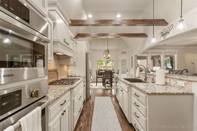 3117 S Hemlock Ct, Broken Arrow, OK 74012 - kitchen with a sink, backsplash, dark wood-type flooring, stainless steel appliances, and a kitchen island with sink