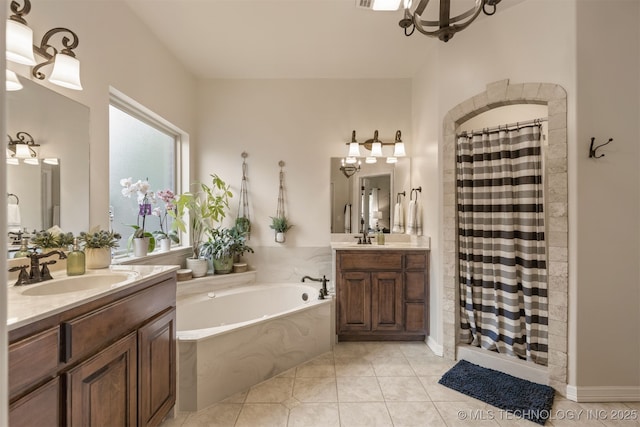 3117 S Hemlock Ct, Broken Arrow, OK 74012 - bathroom with a shower stall, a garden tub, two vanities, tile patterned floors, and a chandelier