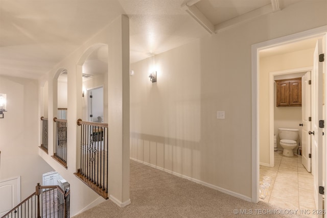 3117 S Hemlock Ct, Broken Arrow, OK 74012 - corridor with light carpet, baseboards, an upstairs landing, and arched walkways