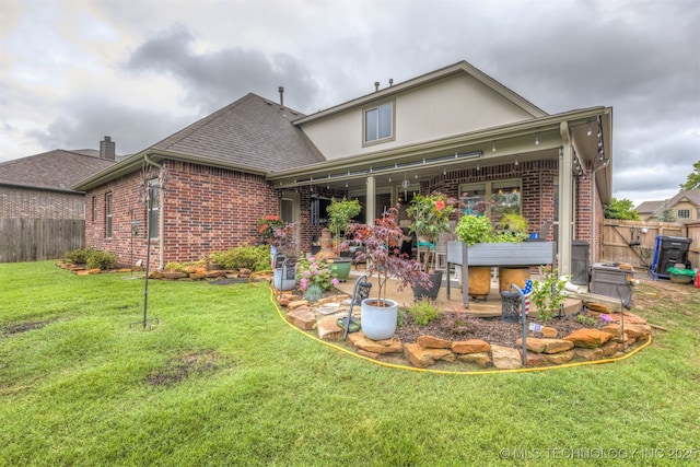 3117 S Hemlock Ct, Broken Arrow, OK 74012 - back of property with brick siding, a patio, stucco siding, and roof with shingles