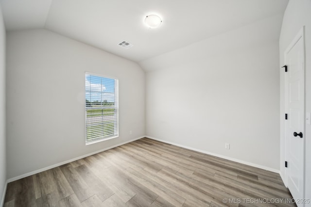 12503 N 130th Ave E, Collinsville, OK 74021 - unfurnished bedroom with lofted ceiling, wood finished floors, and baseboards